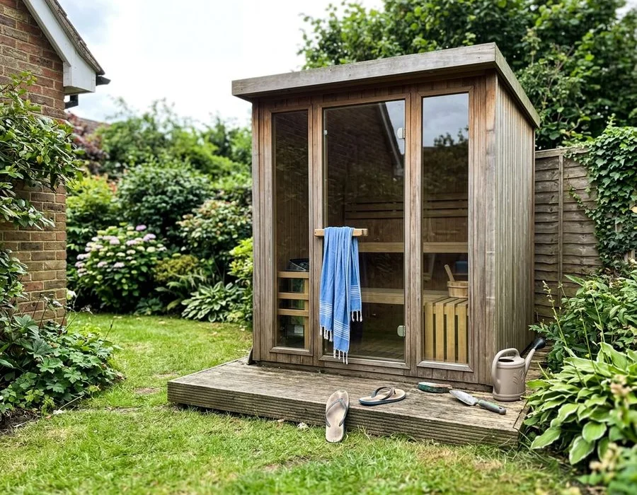 Cedar-clad outdoor sauna with tempered glass front