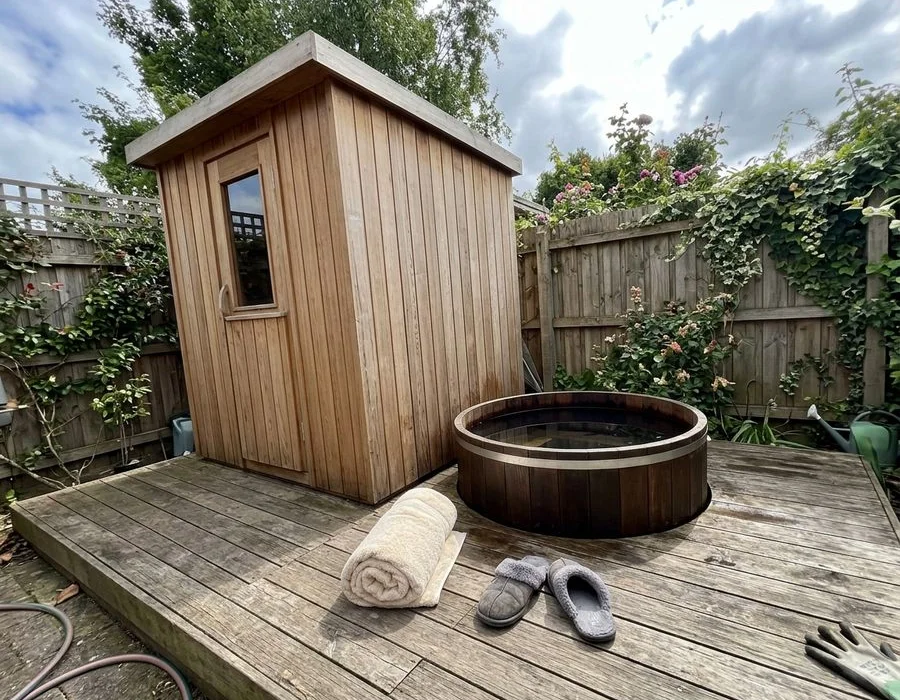 Compact garden sauna with cold plunge tub alongside
